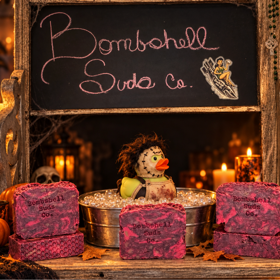 Da Butcher red and dark marbled soap bars displayed with a spooky duck, candles, and a Bombshell Suds Co sign.